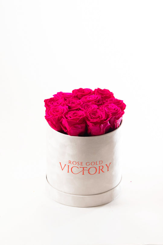 Hot pink preserved roses in a small round suede box — Rose Gold Victory