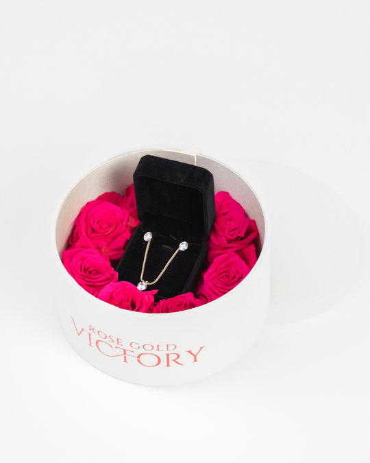 Hot pink preserved roses with a gold jewelry set in a white round box — Rose Gold Victory