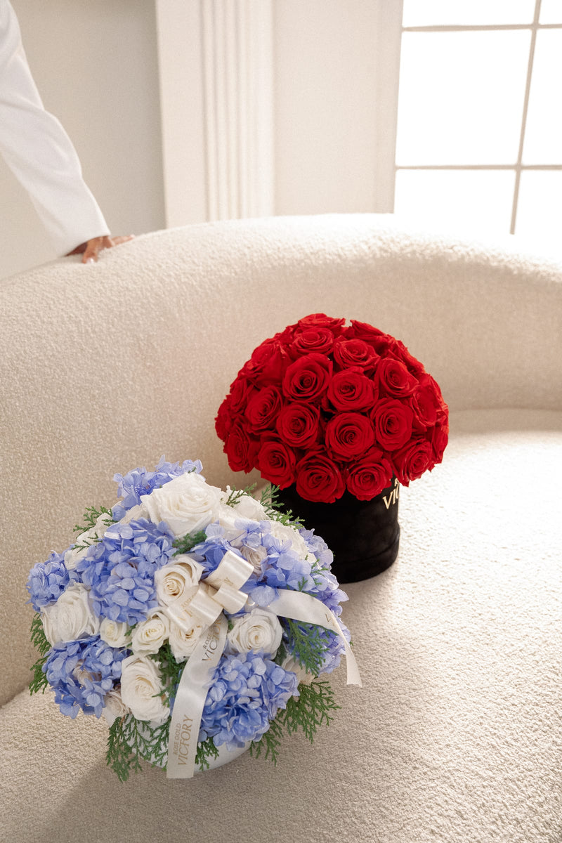 Model presenting a Rose Gold Victory red-rose dome box in a bright modern interior